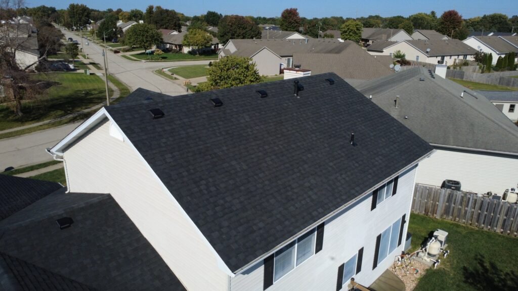 Close-up of new black IKO Blackstone shingles and roof vents on a two-story Springfield, IL home