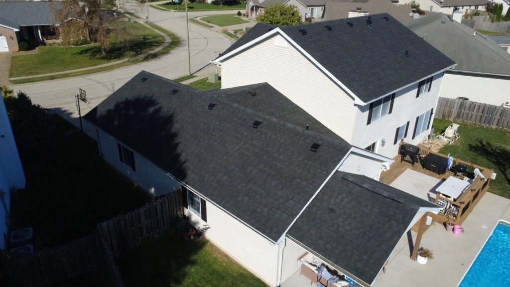 New black IKO Blackstone shingle roof on a Springfield, IL home, seen from the back over the deck and pool