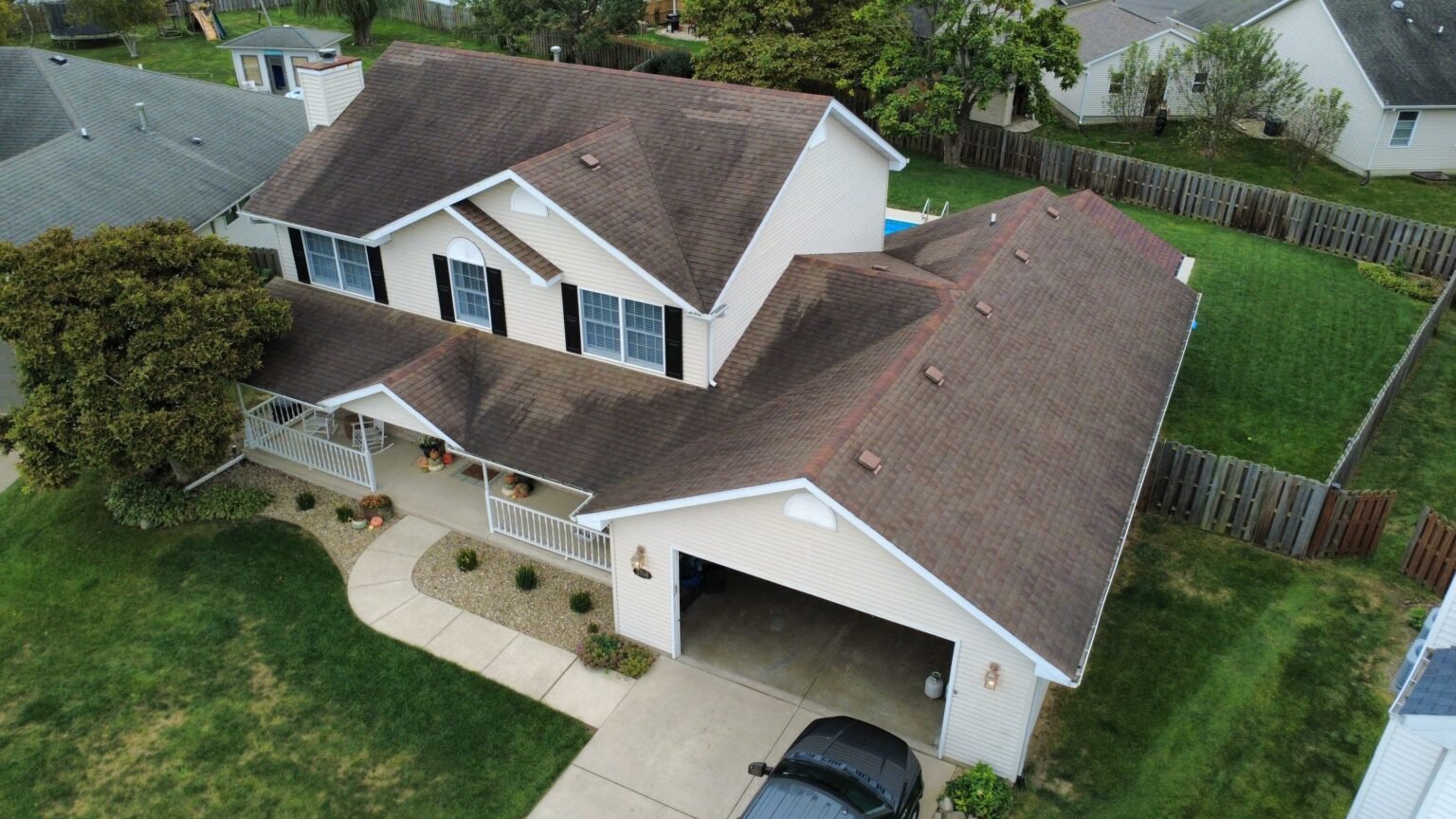 Front of a two-story Springfield, IL home with an aging brown shingle roof before replacement