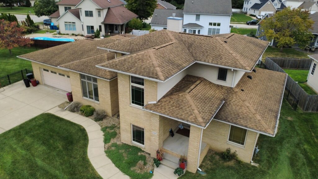 Aerial front view of a Springfield, IL home with its old, weathered brown asphalt shingle roof before replacement