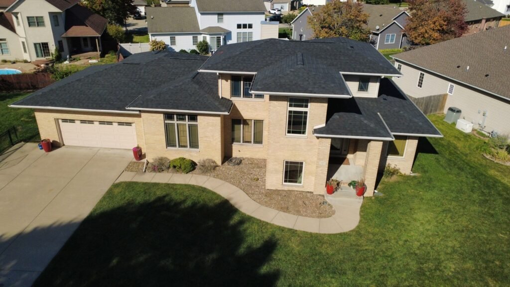 Wide aerial front view of a Springfield, IL home after its roof replacement with dark IKO Dynasty Blackstone shingles